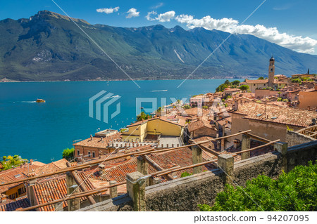 Idyllic Lake Garda above Limone sul Garda old town with boat, Italian alps Idyllic Lake Garda above Limone sul Garda old town with boat, Italian alps 94207095