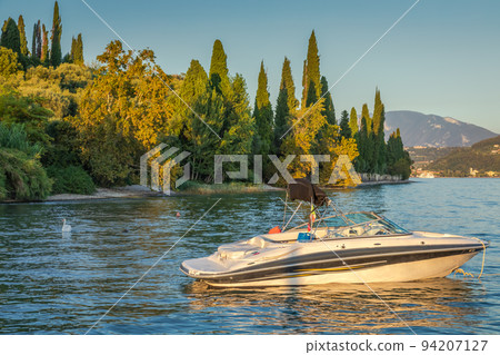 Idyllic lake Garda coastline in Lazise with boats, Northern Italy Idyllic lake Garda coastline in Lazise with boats, Northern Italy 94207127