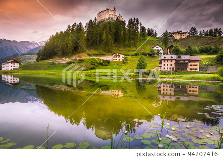 Tarasp with colorful wildflowers and meadows at springtime, Engadine, Swiss Alps Tarasp with colorful wildflowers and meadows at springtime, Engadine, Swiss Alps 94207416