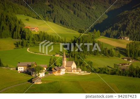 St. Magdalena with famous church in Val di Funes at sunset, Dolomites , Italy 94207423