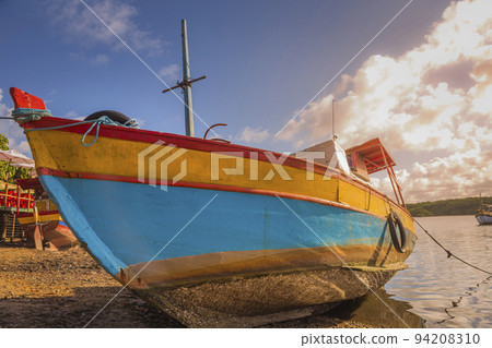 Bay at sunset with fishing trawler rustic boats in Porto Seguro, BAHIA, Brazil Bay at sunset with fishing trawler rustic boats in Porto Seguro, BAHIA, Brazil 94208310