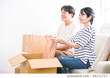 A couple packing cardboard for moving work A couple packing cardboard for moving work 94211717