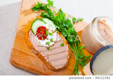 Pate on toasted bread with fresh cheese on wooden board Pate on toasted bread with fresh cheese on wooden board 94212382