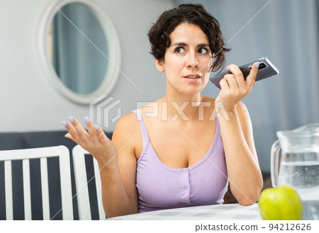 Positive joyful brunette woman talking on mobile phone 94212626