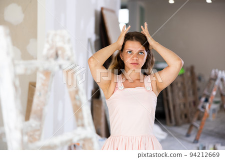 Portrait of tired woman in apartment during repair works 94212669