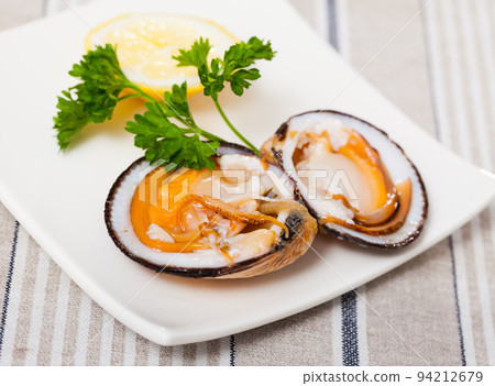 Raw bivalve mollusks with lemon 94212679