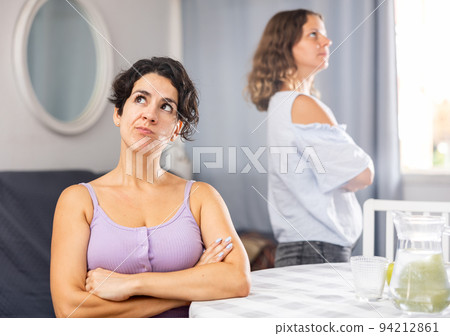 Offended girlfriends ignoring each other after quarrel 94212861