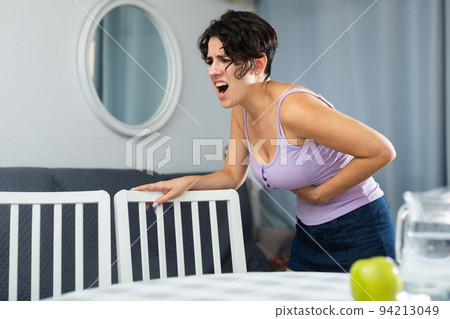 Young woman holding hands on the illness stomache Young woman holding hands on the illness stomache 94213049