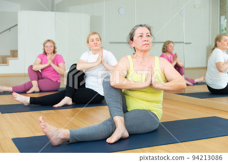 Women are doing lord of the fishe pose Women are doing lord of the fishe pose 94213086