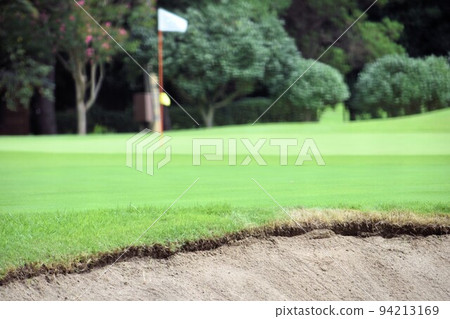 Golf course green and white flag 94213169