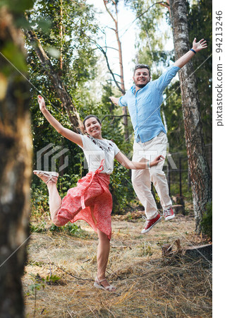 Portrait of a young couple in love on a date in the woods. Vertical photo. 94213246