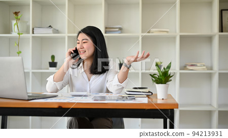 Professional Asian businesswoman or manager is talking on the phone Professional Asian businesswoman or manager is talking on the phone 94213931