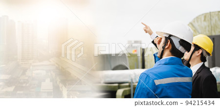 Professional Asian foreman and construction manager talking - discussing about building structure plant together. Businessman and construction engineer having a discussion. 94215434