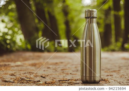 Water bottle. Reusable steel thermo water bottle on green grass. Sustainable lifestyle. Plastic free zero waste free living. Go green Environment protection Water bottle. Reusable steel thermo water bottle on green grass. Sustainable lifestyle. Plastic free zero waste free living. Go green Environment protection 94215694