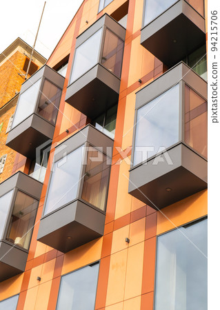 Modern buildings on Granary Island over the Motlawa River in Old Town. Abstract structure. Creative photo Tourism on the Motlawa River. New Apartments architecture glass windows with reflections Modern buildings on Granary Island over the Motlawa River in Old Town. Abstract structure. Creative photo Tourism on the Motlawa River. New Apartments architecture glass windows with reflections 94215706