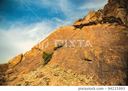 An ancient Buddha image on a stone rock on Tamgaly tas in Almaty region of Kazakhstan 94215993