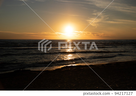 The sea shining in the sunset 94217127