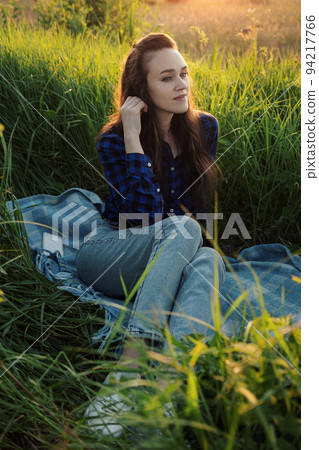 Portrait of a beautiful young woman on meadow Portrait of a beautiful young woman on meadow 94217766