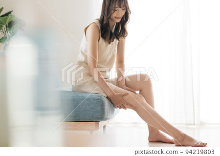 Women with beautiful legs doing swelling care, foot care, and foot massage Women with beautiful legs doing swelling care, foot care, and foot massage 94219803