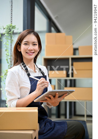 Portrait, Attractive Asian female online business startup in the stock room. 94219947