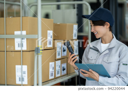 Female staff confirming the product list and the actual product 94220044