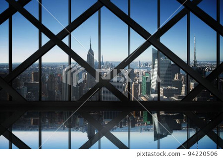 Room with large window looking on city 94220506