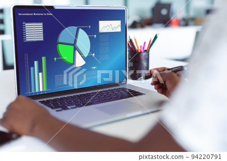 African american businesswoman using laptop with data processing 94220791