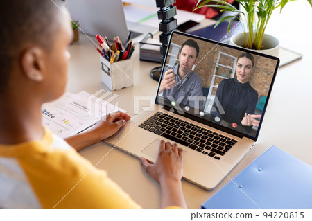 African american businesswoman having video call with colleagues African american businesswoman having video call with colleagues 94220815