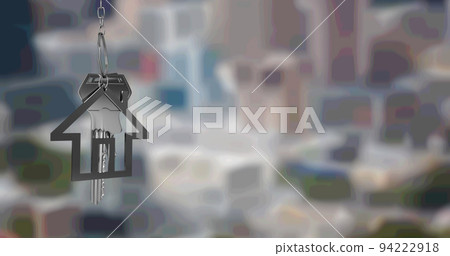 Image of silver house key fob and key, hanging in front of blurred cityscape 94222918