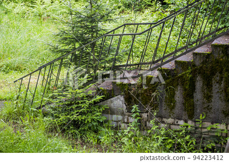 stairs to the terrace of the second floor of an old abandoned boarding house 94223412