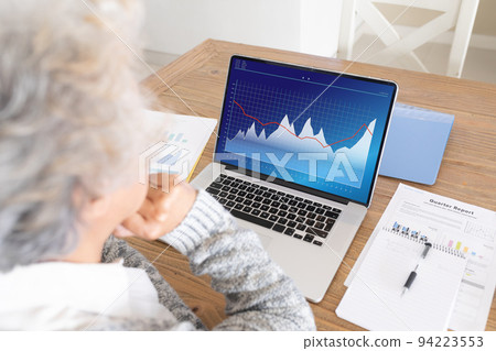 Senior caucasian businesswoman using laptop with data processing Senior caucasian businesswoman using laptop with data processing 94223553