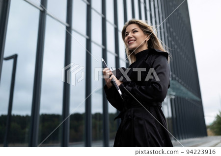 concert of a successful businessman woman who is in a hurry on business with a mobile phone with a concert of a successful businessman woman who is in a hurry on business with a mobile phone with a 94223916