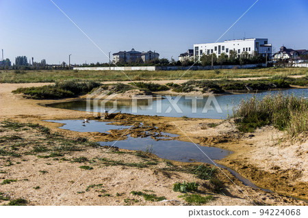 a shallow salty lagoon near the Azov Sea on the Arabat Spit, Ukraine a shallow salty lagoon near the Azov Sea on the Arabat Spit, Ukraine 94224068