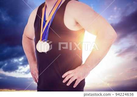 Midsection of medalist against sky Midsection of medalist against sky 94224636