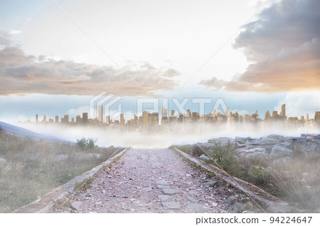 Rocky path leading to large urban sprawl Rocky path leading to large urban sprawl 94224647