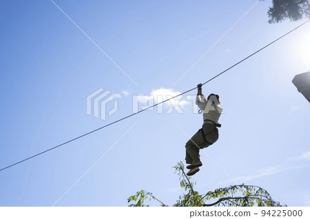 Woman sliding down a zipline 94225000