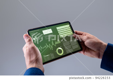 Caucasian businessman using tablet with data processing Caucasian businessman using tablet with data processing 94226153