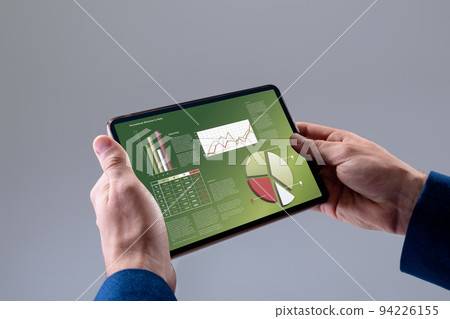 Caucasian businessman using tablet with data processing Caucasian businessman using tablet with data processing 94226155
