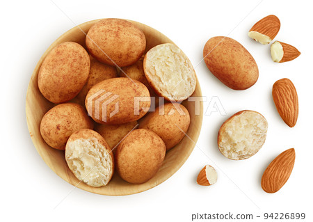 Marzipan balls or potatoes with almond in wooden bowl isolated on white background full depth of field. Top view. Flat lay Marzipan balls or potatoes with almond in wooden bowl isolated on white background full depth of field. Top view. Flat lay 94226899