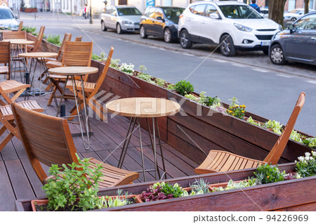 Empty table in outdoor cafe or restaurant. Tables and chairs at sidewalk cafe. Touristic setting, cafe table, sidewalk cafe furniture. Empty table in outdoor cafe or restaurant. Tables and chairs at sidewalk cafe. Touristic setting, cafe table, sidewalk cafe furniture. 94226969