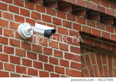 Security camera on modern building. Professional surveillance camera. CCTV on the wall with LED IR lights. Security system, technology concept. Video equipment for safety system area control outdoor 94227090