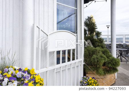 Empty metal board outdoors. Horizontal signage on restaurant or store front with glass windows. Empty metal board outdoors. Horizontal signage on restaurant or store front with glass windows. 94227093