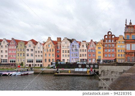 Historic Old Town of Gdansk in Poland, colourful houses on embankment in rainy weather. 94228391