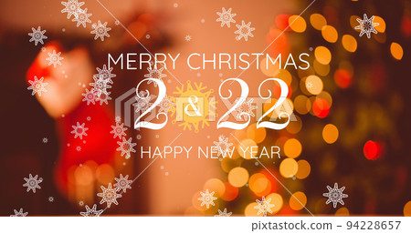 Image of merry christmas text over ligh spots and snow falling 94228657
