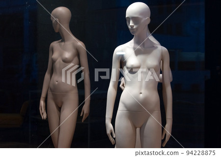 Naked female mannequins in the shop window. Fashion clothing woman mannequin in the store. 94228875