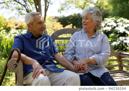 Senior caucasian couple spending time in garden together Senior caucasian couple spending time in garden together 94230204