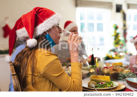 Caucasian woman sitting at table for dinner 94230402