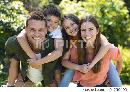 Portrait of caucasian family spending time in their garden together 94230403
