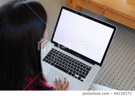 Mixed race woman sitting on a couch at home 94230575