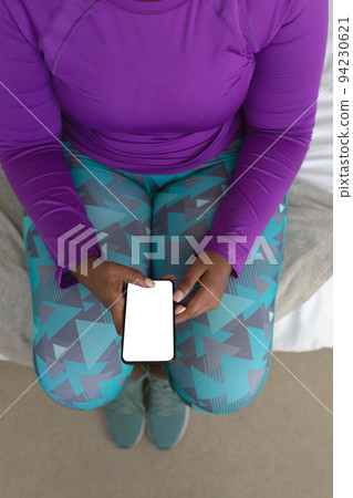 African american female vlogger using smartphone wearing sports clothes African american female vlogger using smartphone wearing sports clothes 94230621